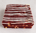 Red Velvet Fever brownie with white chocolate chips and white chocolate drizzle