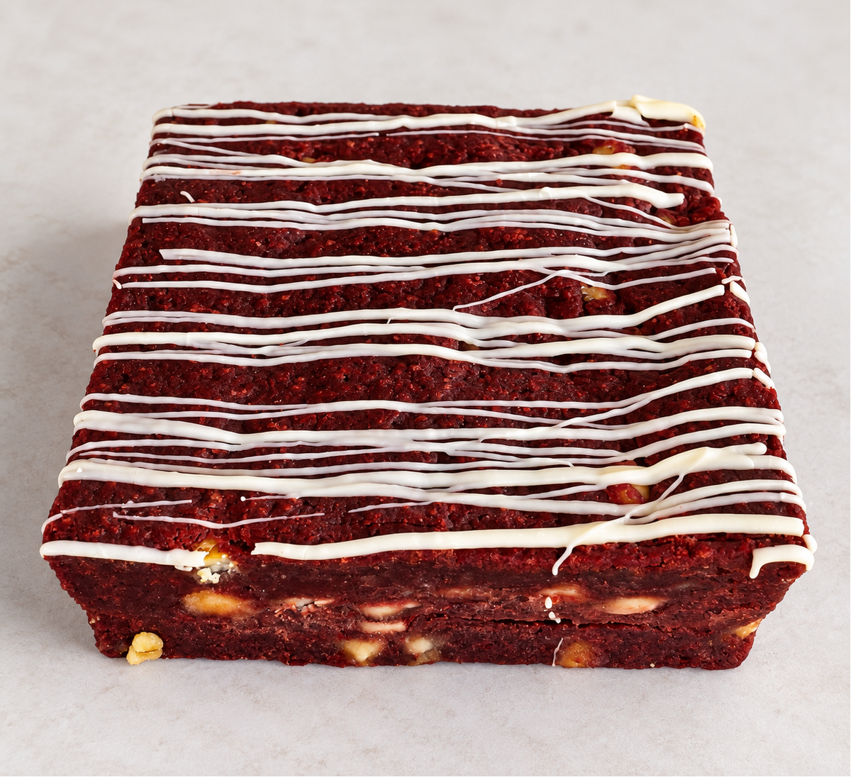 Red Velvet Fever brownie with white chocolate chips and white chocolate drizzle